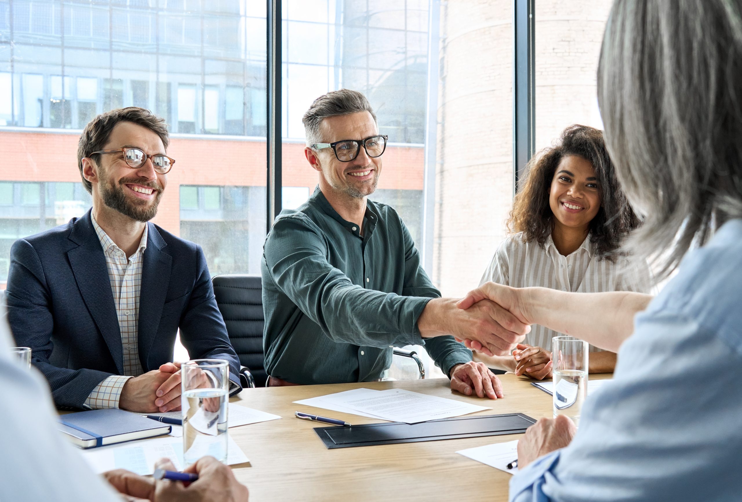 Business owners and acquisition partners reaching an agreement
